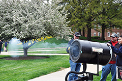 Maryland Day attendees fire the vortex cannon, Dan Lathrop explains