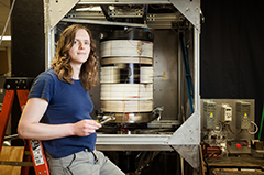 Grad Student Freja Nordsiek sits by the Taylor Couette experiment